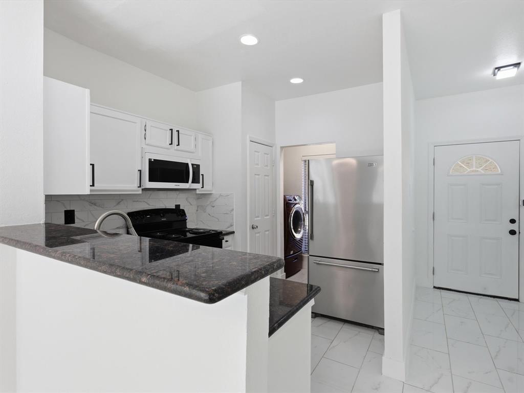 3801 14th Street, Unit 1302 Plano, TX 75074 - Photo 8 of 25 a kitchen with stainless steel appliances granite countertop a refrigerator a stove a sink a microwave and cabinets