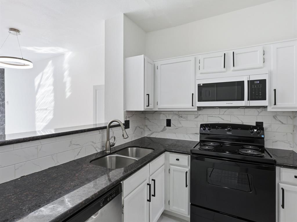 3801 14th Street, Unit 1302 Plano, TX 75074 - Photo 10 of 25 a kitchen with stainless steel appliances granite countertop white cabinets a stove top oven and granite counter tops