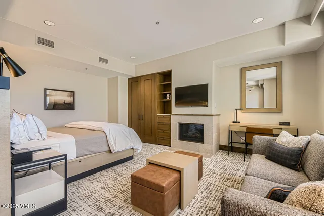 a bedroom with a bed a couch and dresser