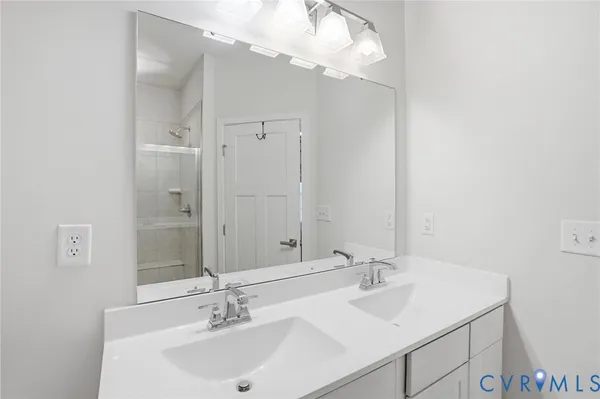 a bathroom with a sink vanity and a mirror