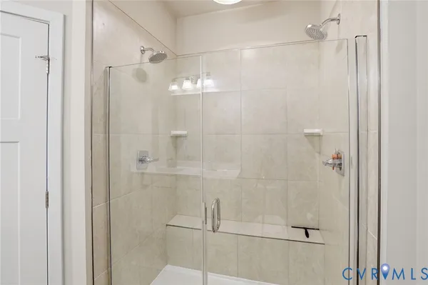 a bathroom with a glass shower door