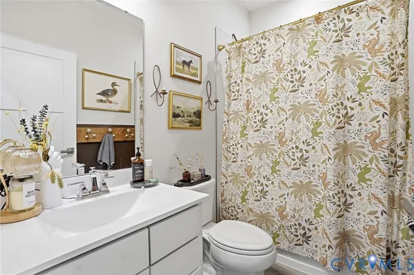 a bathroom with a sink toilet and mirror
