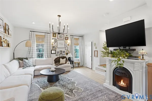 a living room with furniture a flat screen tv and a fireplace