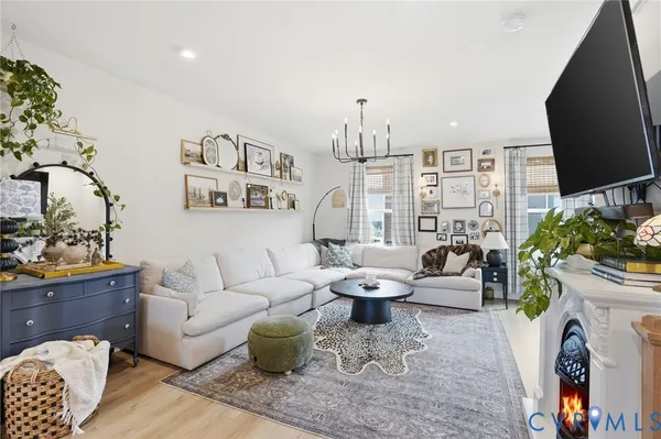 a living room with furniture a rug and a flat screen tv