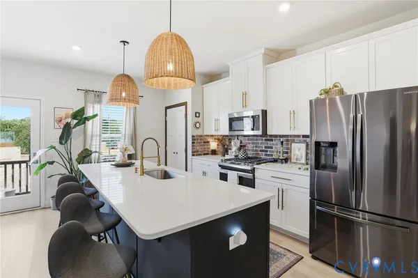a kitchen with refrigerator cabinets and living room