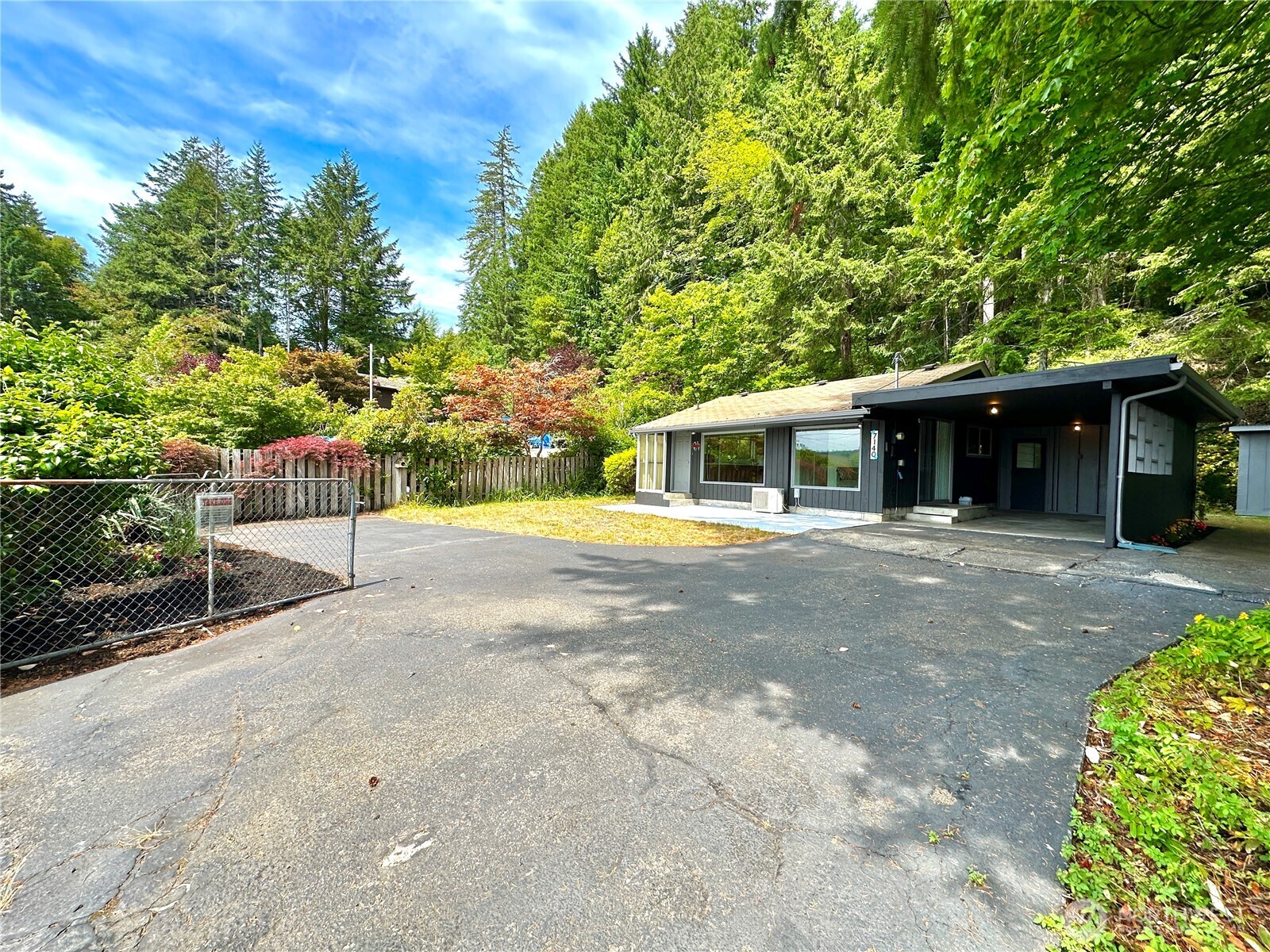 7140 Northeast North Shore Road Belfair, WA 98528 - Photo 1 of 31 a front view of a house with a garden