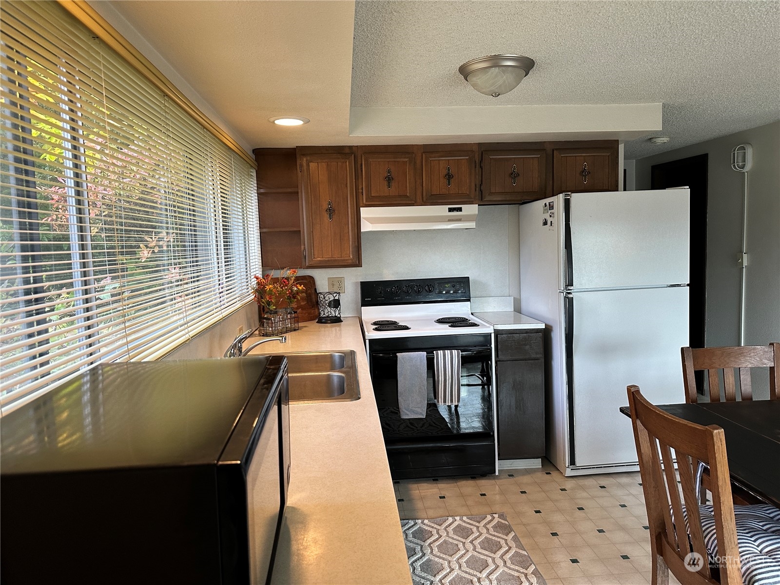 7140 Northeast North Shore Road Belfair, WA 98528 - Photo 11 of 31 a kitchen with stainless steel appliances granite countertop a refrigerator a stove and a sink