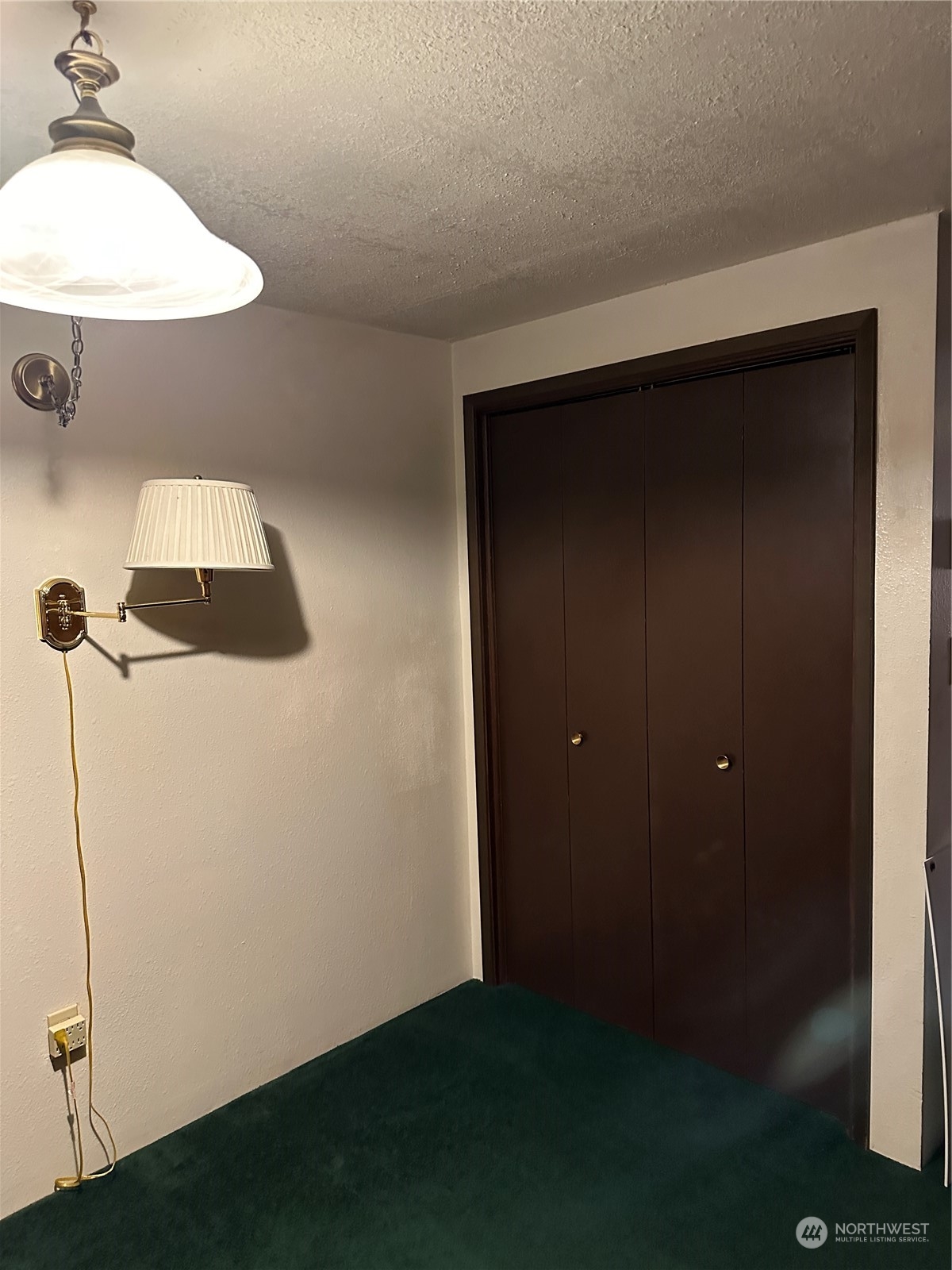 7140 Northeast North Shore Road Belfair, WA 98528 - Photo 22 of 31 a room with a mirror and a wooden floor