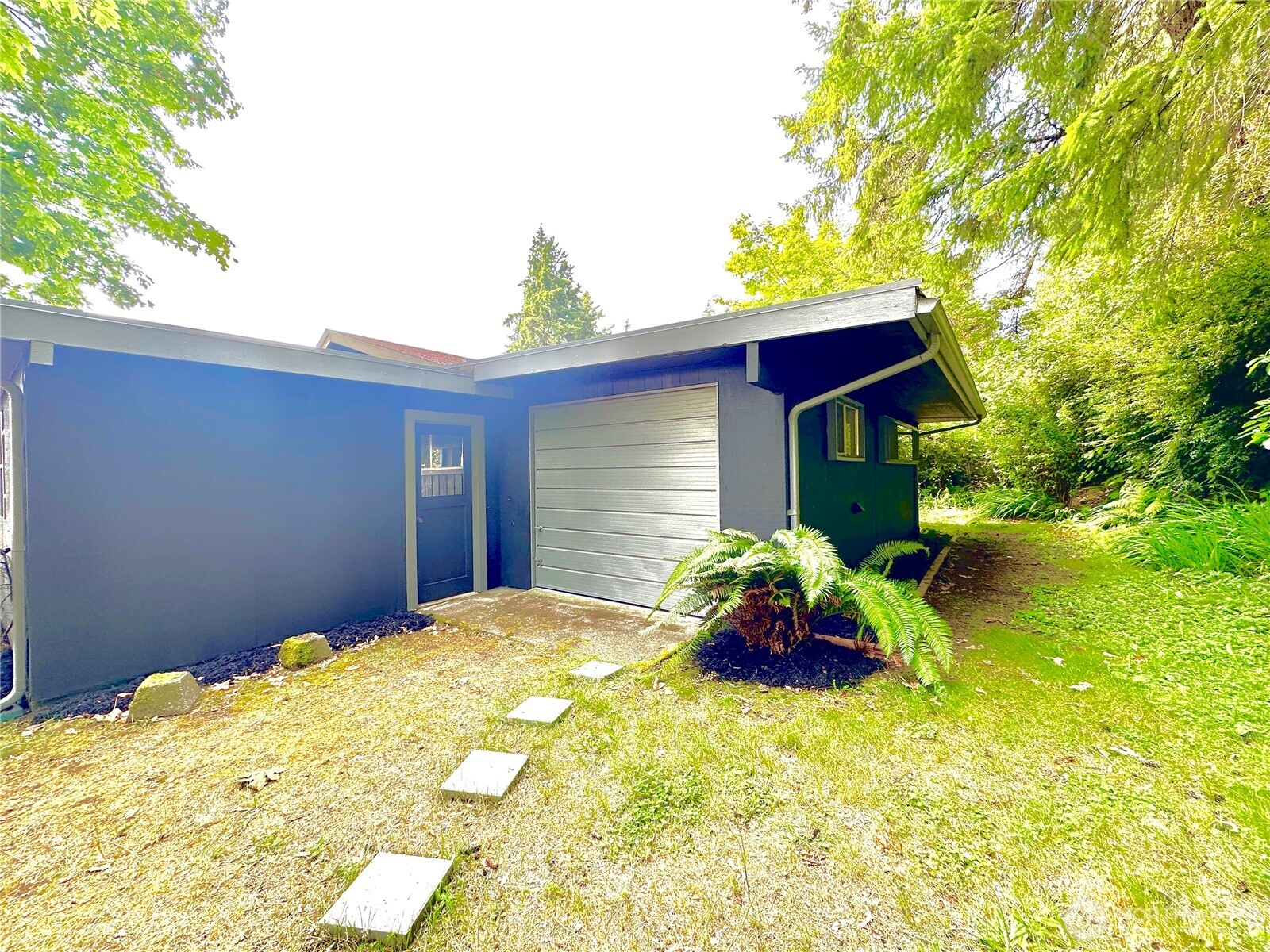 7140 Northeast North Shore Road Belfair, WA 98528 - Photo 29 of 31 a front view of a house with a yard