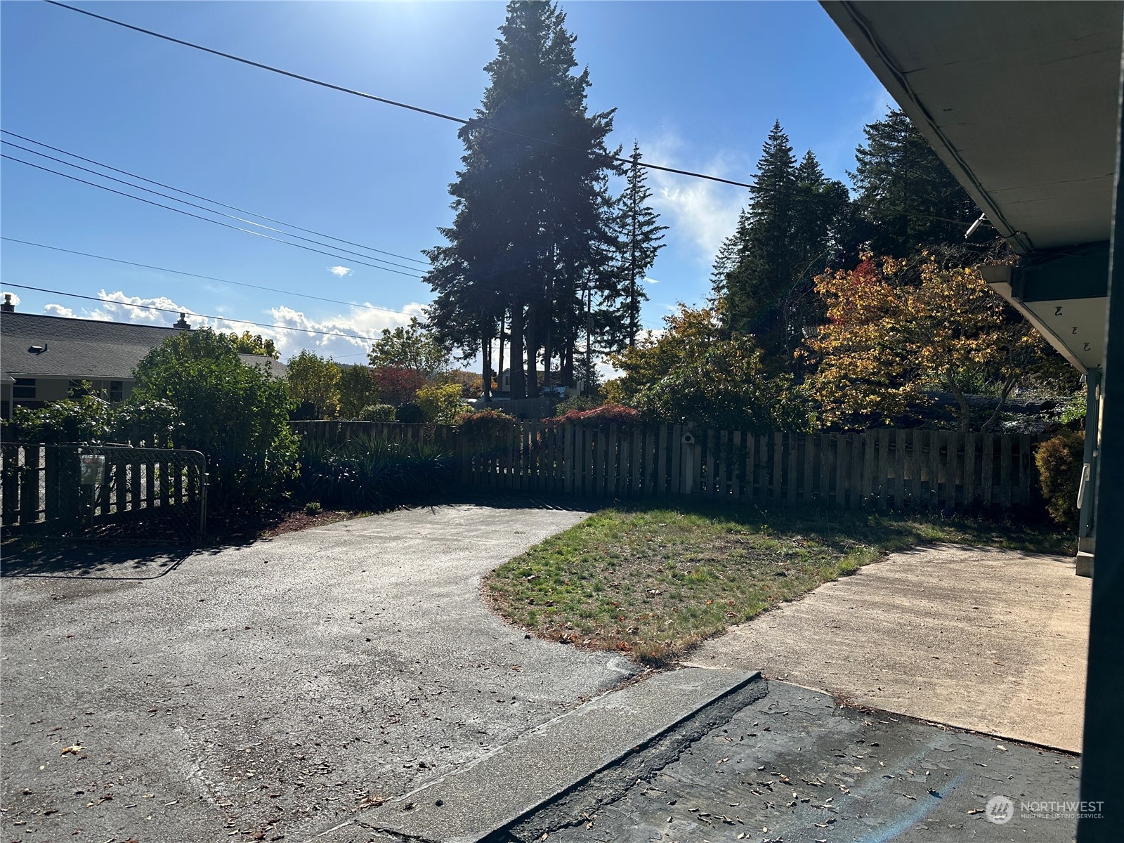 7140 Northeast North Shore Road Belfair, WA 98528 - Photo 7 of 31 a street view with wooden fence