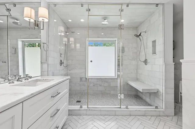 a bathroom with a shower sink and mirror