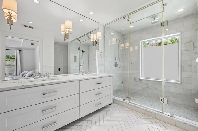 a bathroom with a shower sink and mirror