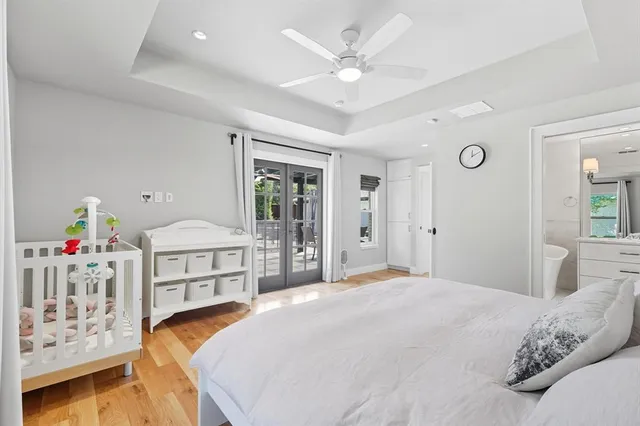 a bedroom with a bed a window and dresser