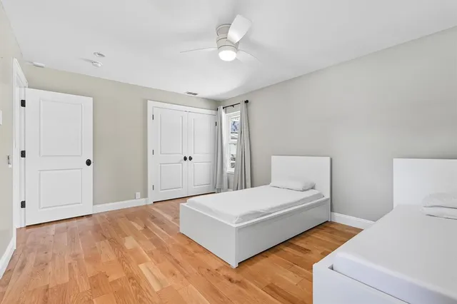 a bedroom with a bed and a ceiling fan