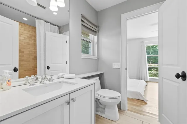 a bathroom with a sink a toilet and shower