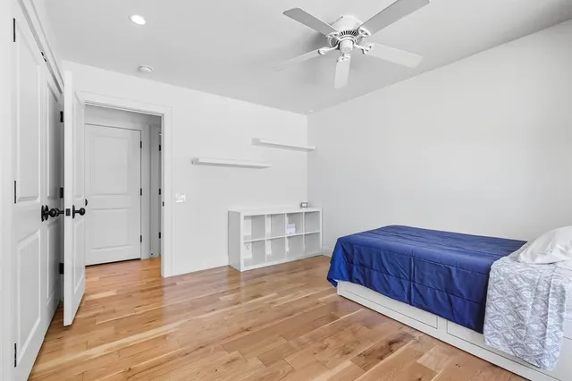 an empty room with a cabinet and mirrors
