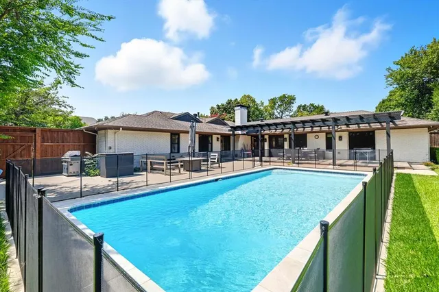 a view of a house with pool and a chairs