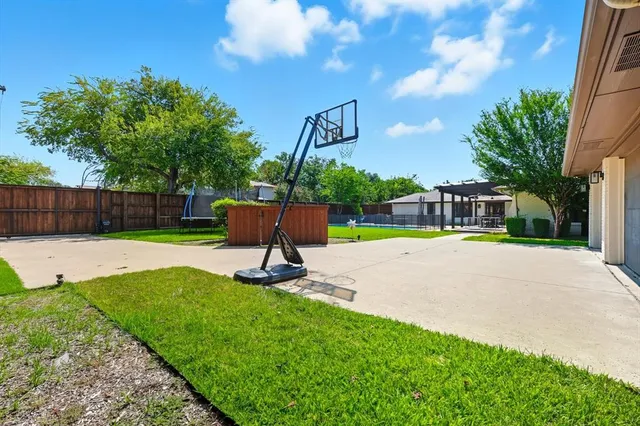 a view of a backyard with a garden and entertaining space