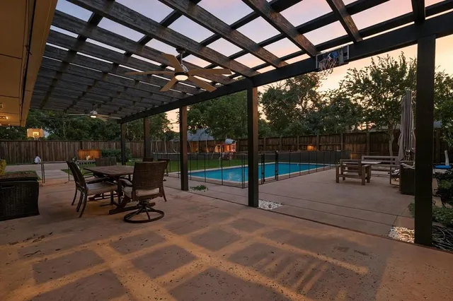 a view of a porch with furniture and a yard