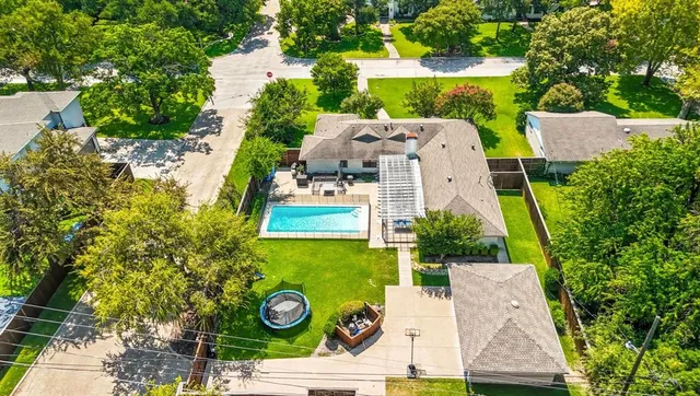 an aerial view of a house with garden space and street view