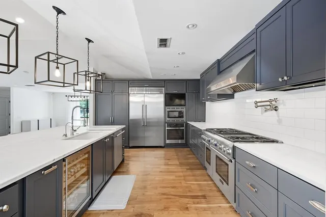 a kitchen with granite countertop a sink stove and cabinets