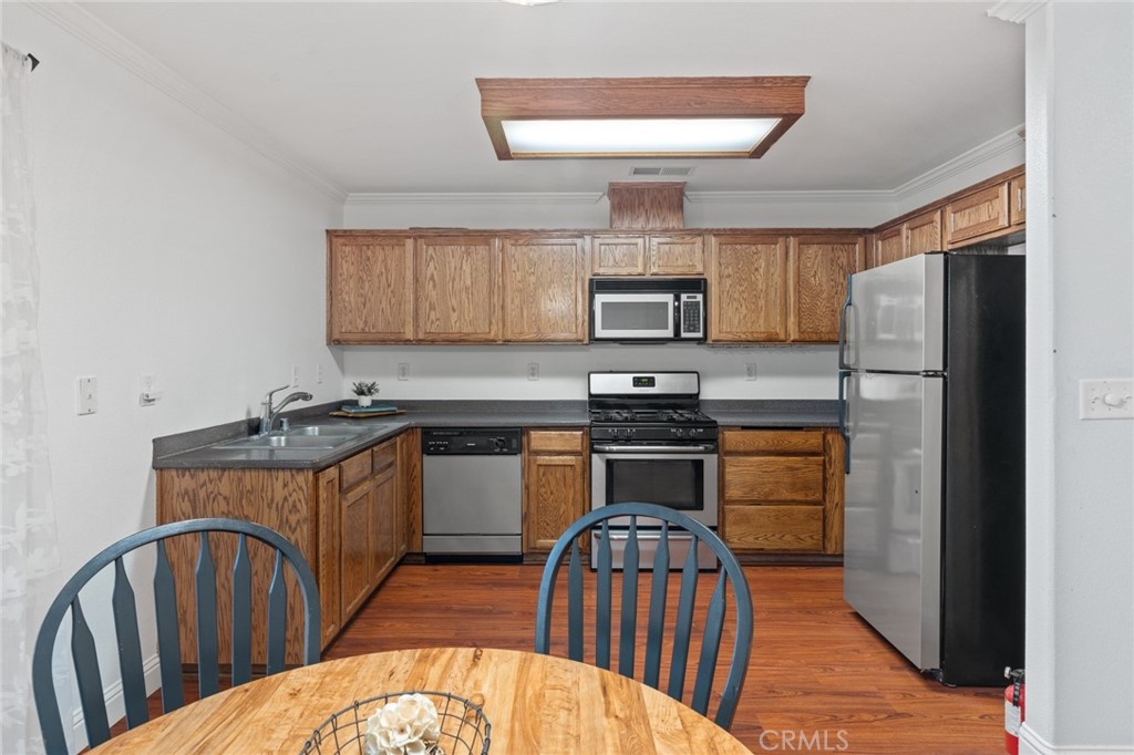 1587 Lexus Lane Chico, CA 95926 - Photo 9 of 25 a kitchen with stainless steel appliances a stove a sink dishwasher a refrigerator and a fireplace