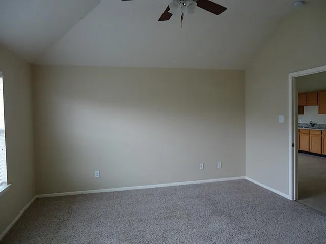 an empty room with a empty space and windows