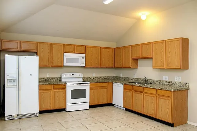 a kitchen with a stove sink and cabinets
