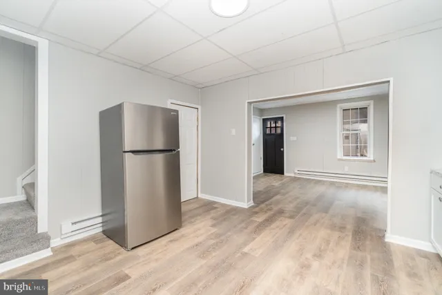a view of empty room with wooden floor and cabinet