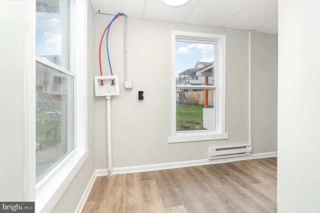 a view of a room that has a window and kitchen view