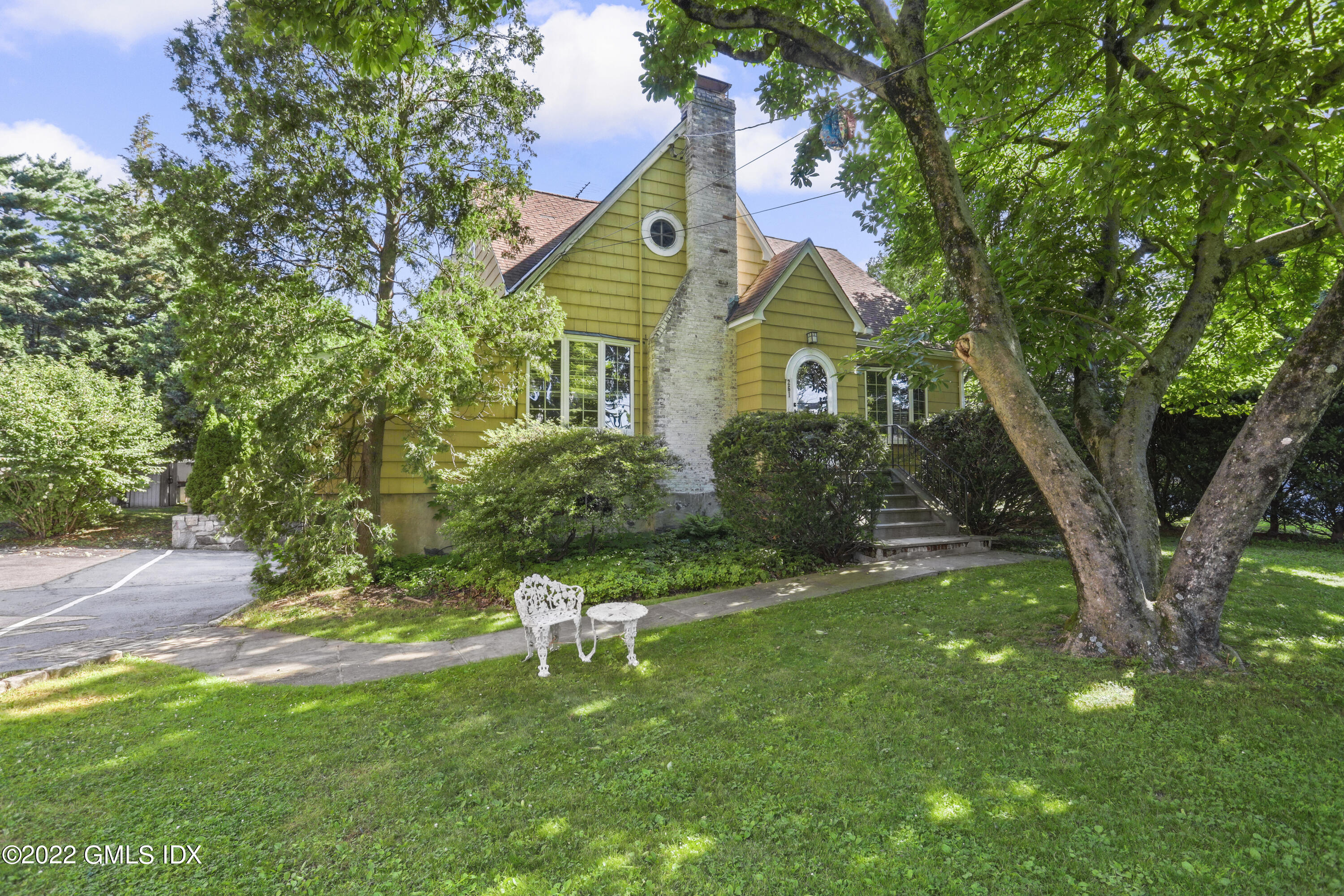 a front view of house with a garden