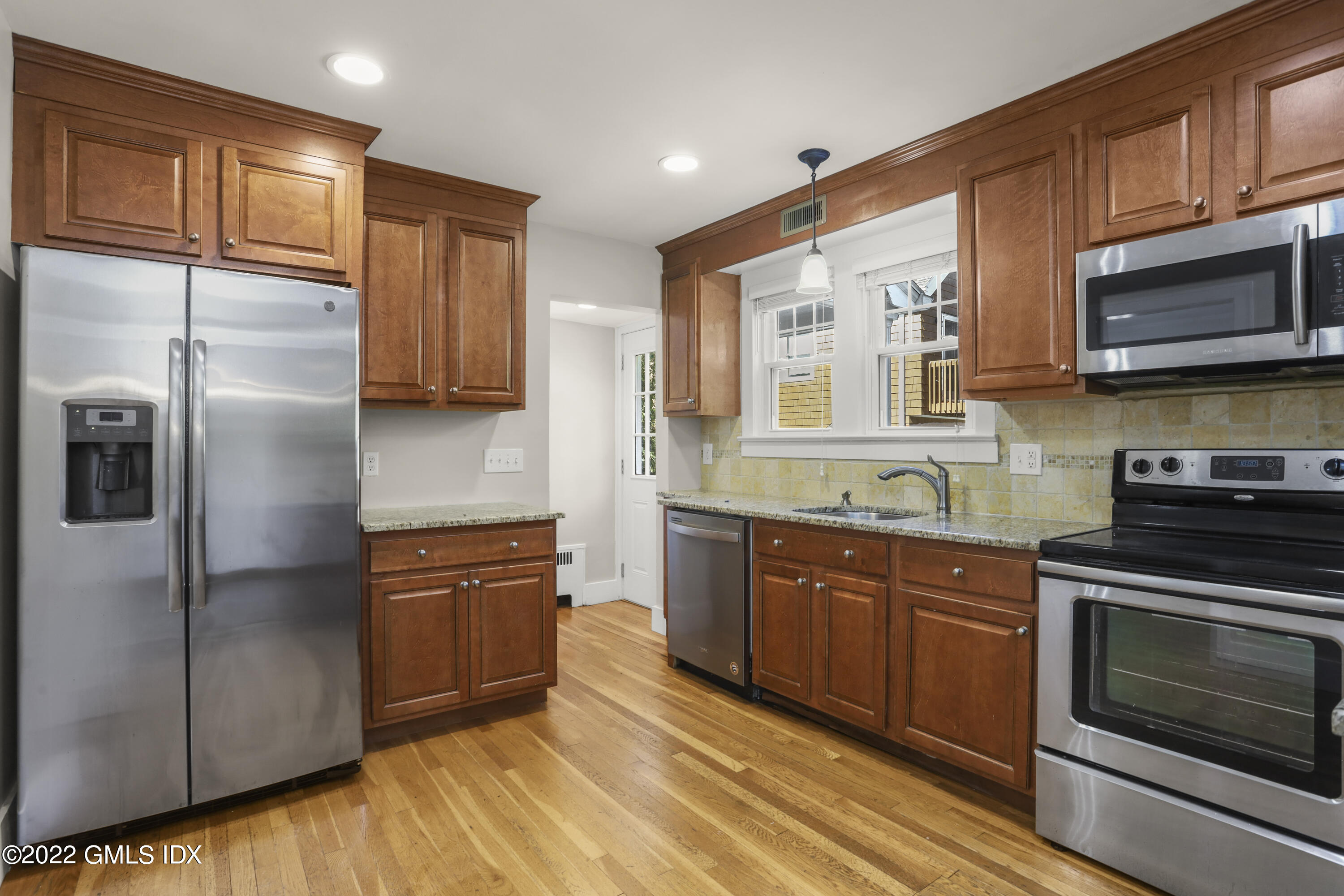 261 Pemberwick Road Greenwich, CT 06831 - Photo 2 of 13 a kitchen with stainless steel appliances granite countertop a refrigerator a stove top oven a sink and dishwasher