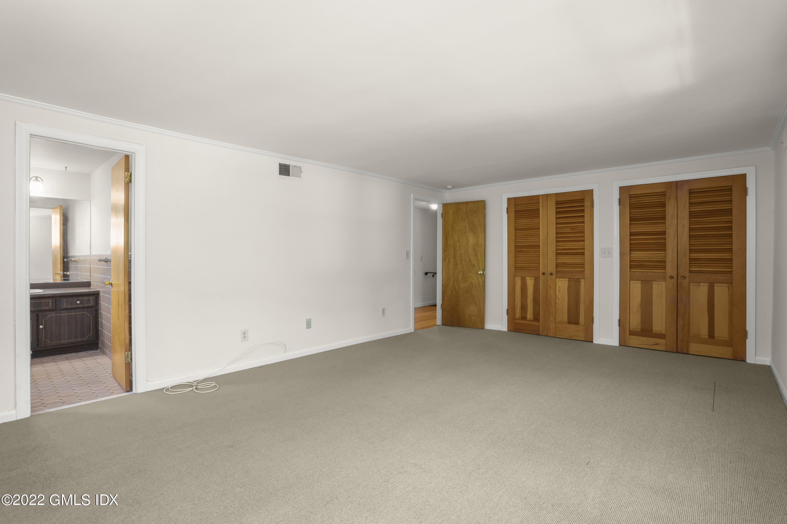 261 Pemberwick Road Greenwich, CT 06831 - Photo 9 of 13 an empty room with a empty space and wooden floor