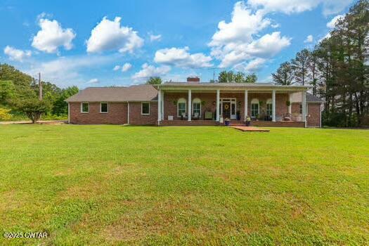 562 Old Jackson Road Henderson, TN 38340 - Photo 1 of 42 a view of a house with a big yard and palm trees