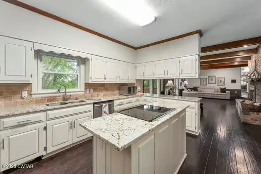 a kitchen with a sink cabinets and window