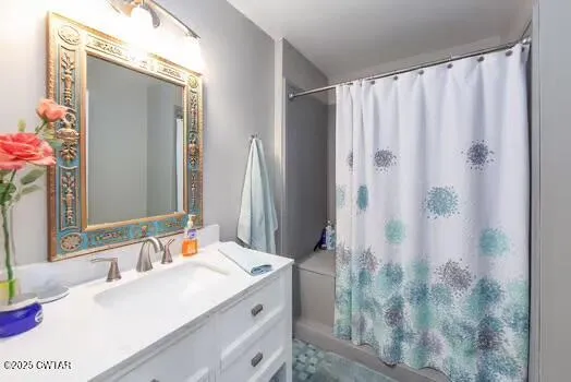 a bathroom with a double vanity sink and shower