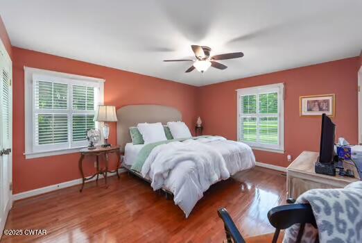 562 Old Jackson Road Henderson, TN 38340 - Photo 18 of 42 a bedroom with a bed and wooden floor