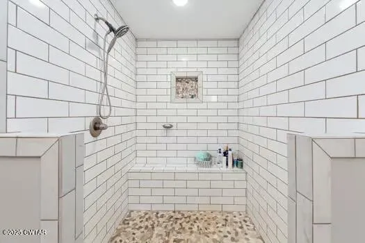 a spacious bathroom with a double vanity sink and a mirror