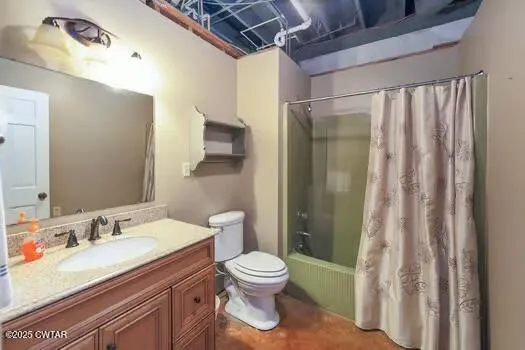 a view of a room with furniture and windows