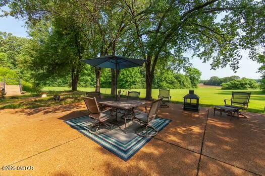 562 Old Jackson Road Henderson, TN 38340 - Photo 37 of 42 a view of a patio with a table chairs and a backyard