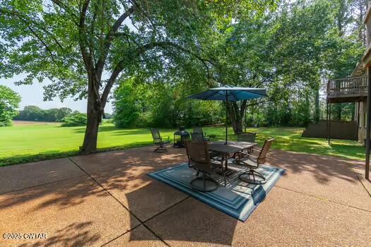 562 Old Jackson Road Henderson, TN 38340 - Photo 38 of 42 a view of a patio with a table chairs and a yard