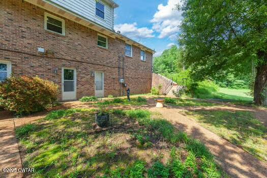 562 Old Jackson Road Henderson, TN 38340 - Photo 39 of 42 a view of a brick house with a yard and large tree