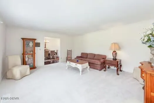 a living room with furniture and a lamp