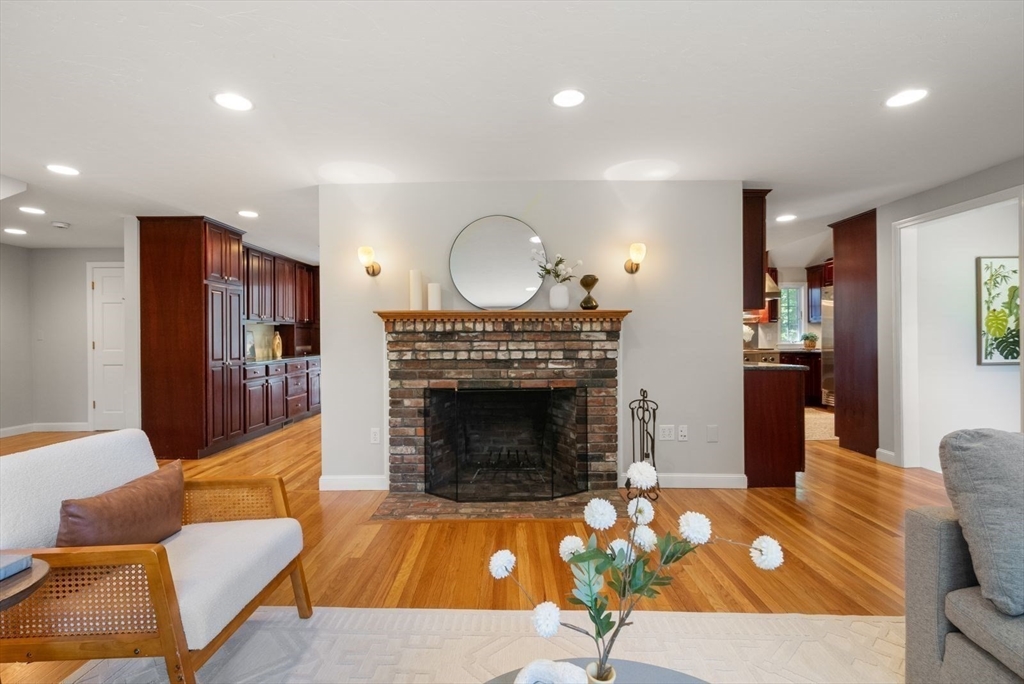 49 Walpole Street Dover, MA 02030 - Photo 13 of 40 a living room with furniture a fireplace and a flat screen tv