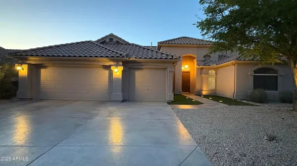 a view of a house with a yard and garage