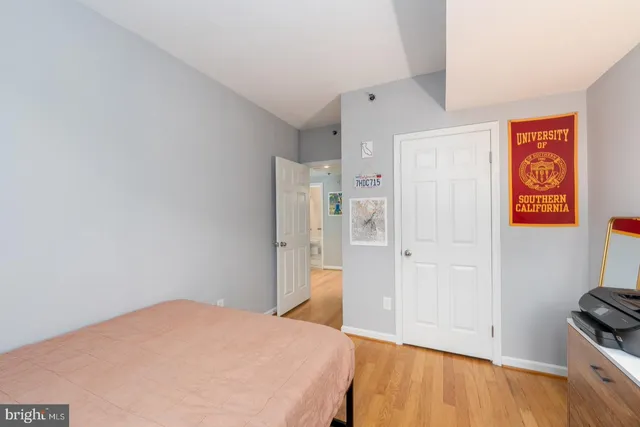 a bedroom with a bed and a view of kitchen