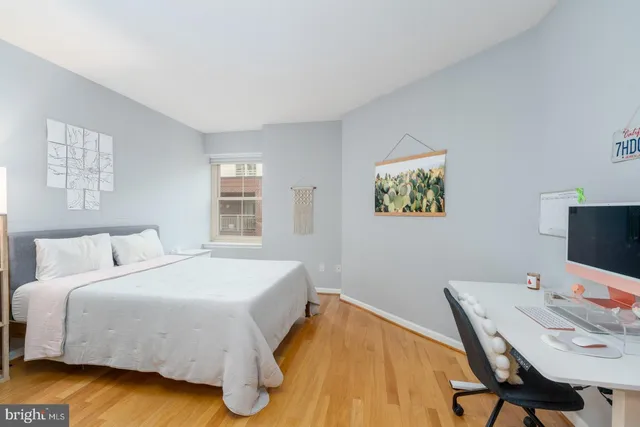 a bedroom with a bed and a desk