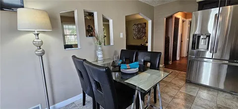 a view of a dining room with furniture and a chandelier
