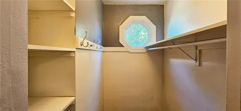 a bedroom with a bed and a mirror