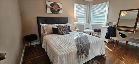 a bedroom with a bed and chair